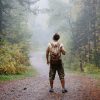 Man walking in a foggy summer forest alone Man walking in a foggy summer forest alone